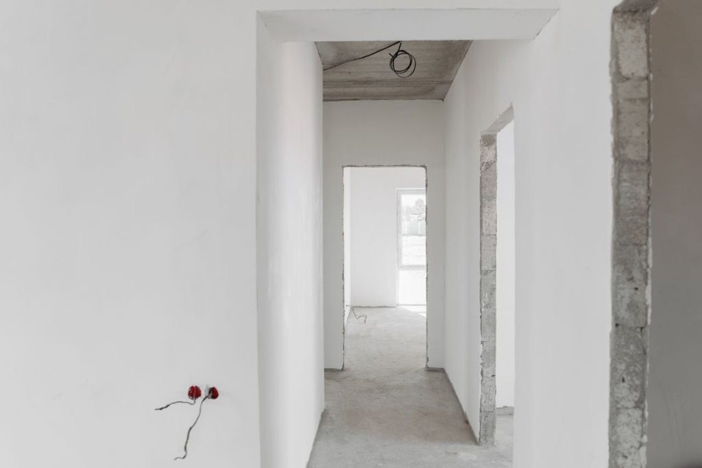 interior-of-unfinished-building-with-white-paint-7937303 A minimalist view of an unfinished building interior with white walls and door frames.